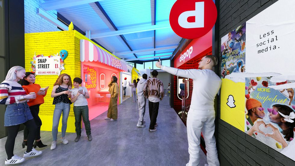 Group of young people posing and taking photos in a bright colorful indoor shopping arcade with neon storefronts and signs