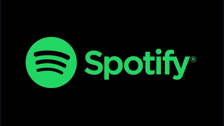 Spotify logo on a black background: green circular icon with black curved lines and the word'Spotify' in green text.