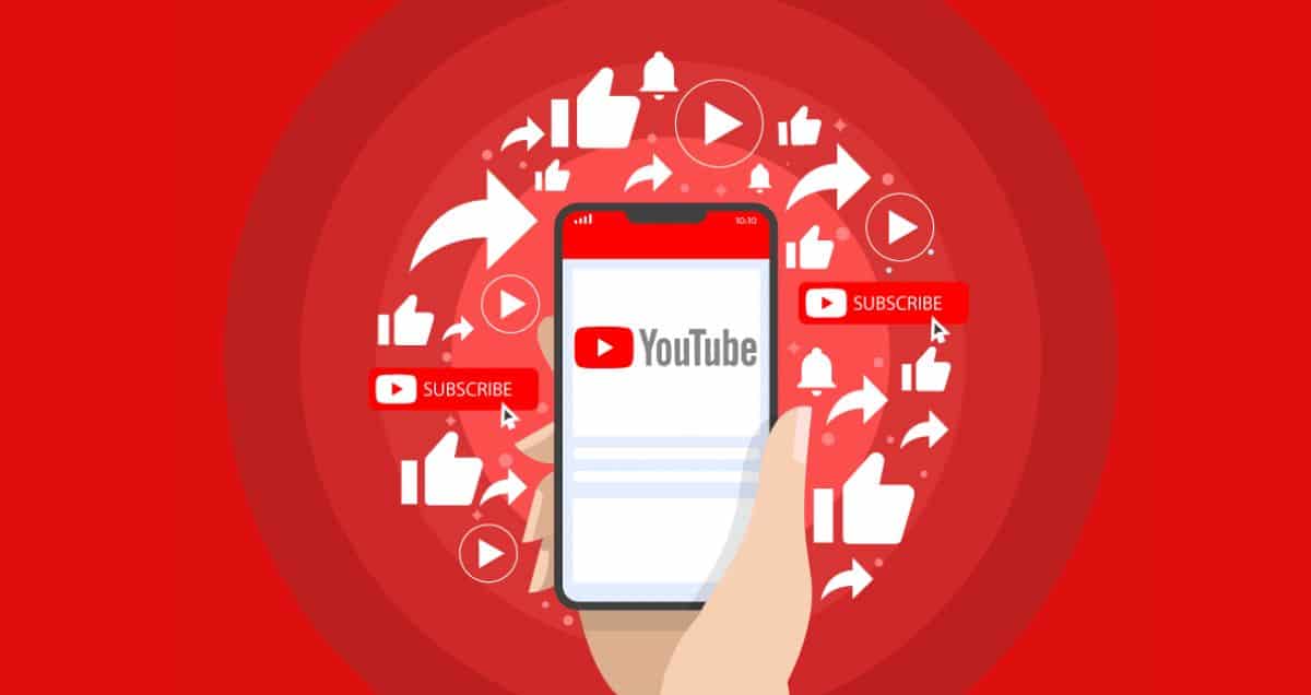 Hand holding a smartphone displaying the YouTube logo, with subscribe, like, and play icons around on a red background.